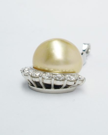 Natural golden pearl & part channel set diamond pendant mounted in palladium and platinum.
