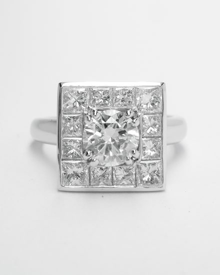 A 13 stone princess cut and round brilliant cut square halo cluster set in platinum.