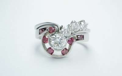 A pink diamond 7 stone open channel set shaped wedding ring shaped to fit around 4 stone comet engagement ring.
