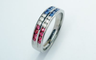 18ct. white gold diamond, sapphire & ruby two row channel set ring.