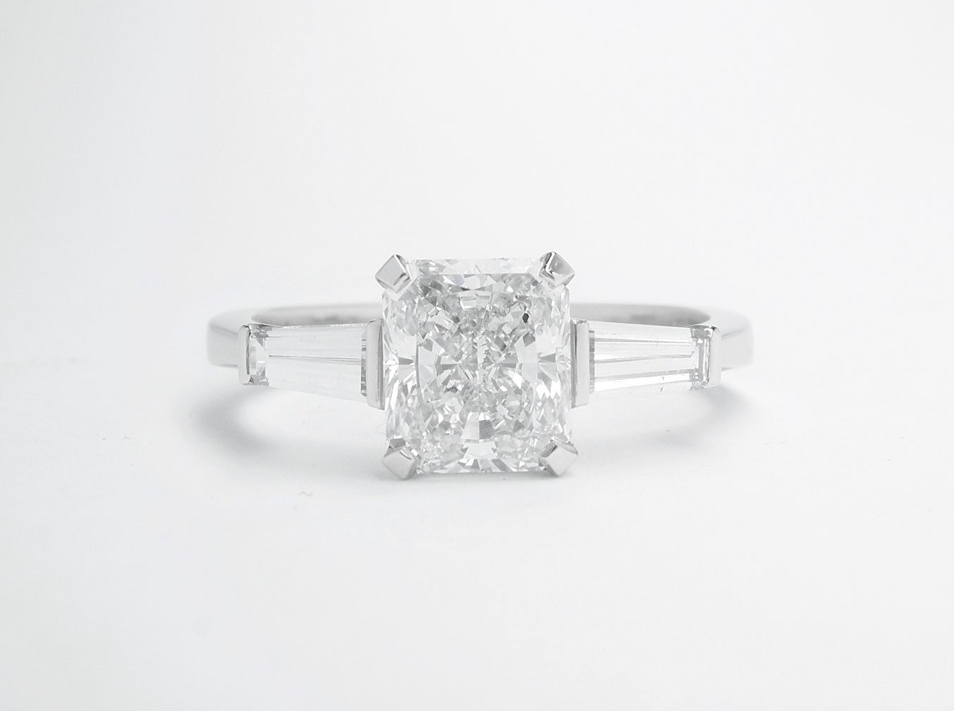 1.20ct. 'D' colour, VS2 clarity radiant cut diamond & tapered baguette diamond ring mounted in platinum.