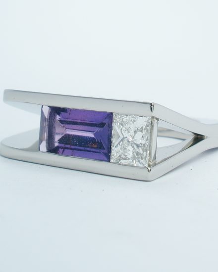 A purple baguette sapphire and princess cut diamond plateau topped square ring mounted in palladium.