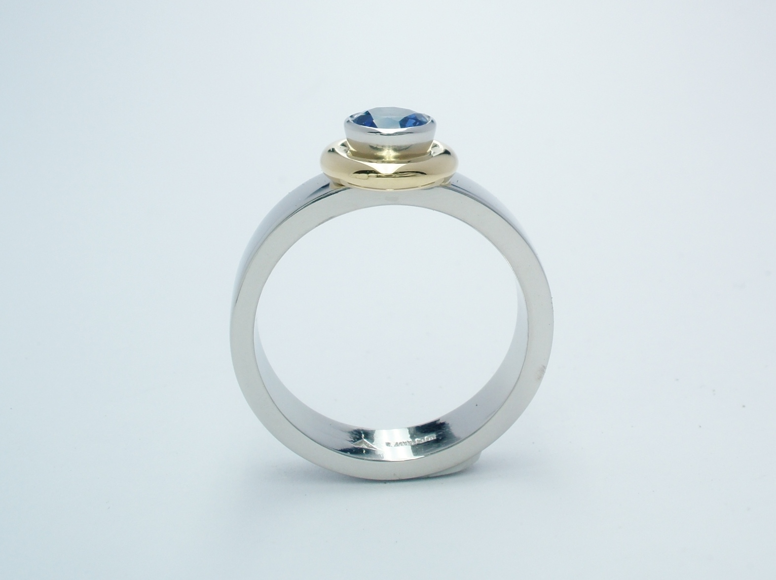 Round sapphire 'doughnut' style ring mounted in palladium, 18ct. yellow gold & platinum.