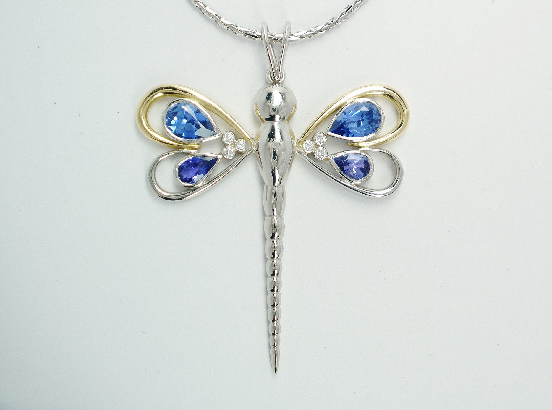 Dragonfly pendant set with pear shaped sapphires, tanzanites and small round diamonds mounted in palladium, 18ct. yellow gold & platinum.