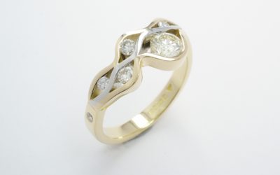 A 6 stone round brilliant cut diamond 'wave' style ring mounted in 18ct. yellow gold and platinum.