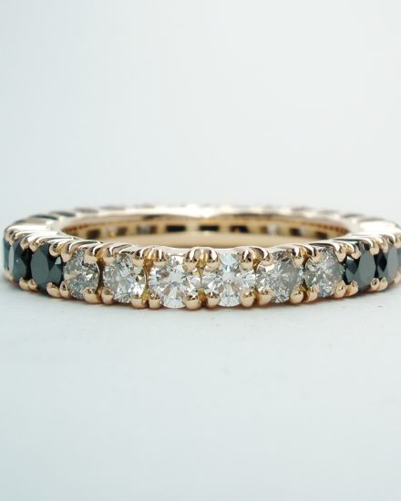 A black, 'grey' & white diamond full hoop diamond ring mounted in red gold.