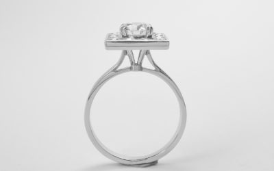 A 13 stone round brilliant cut diamond square channel set ring mounted in platinum.