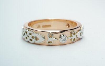 A diamond set red gold lady's wedding ring with platinum Celtic & Kazakh style motif overlays.