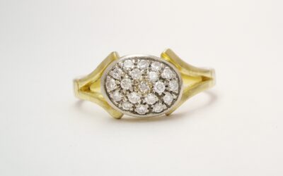An 18ct. yellow gold & platinum topped pave` set diamond oval cluster.