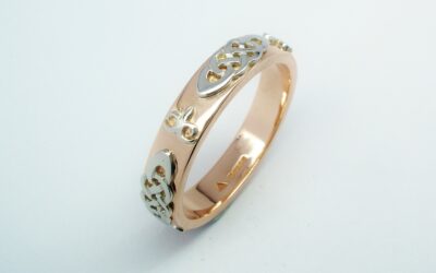 A red gold gent's wedding ring with platinum Celtic and Kazakh style motif overlays.