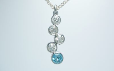 A 5 stone sky blue diamond and white diamond tumble pendant mounted in platinum.