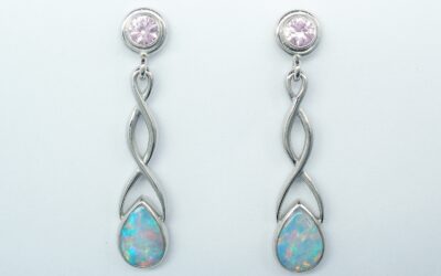 A pair of 18ct. white gold Celtic style drop earrings set with pear shaped opals and round pink sapphires.