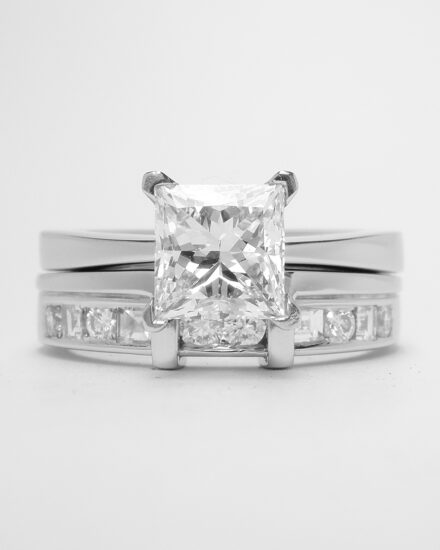A platinum 10 stone square cut & round brilliant cut diamond wedding ring shaped to fit around a single stone princess cut engagement ring.