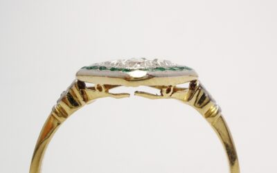 An emerald and diamond cluster, finely made in 18ct. yellow gold & topped in platinum very worn and broken on underside.