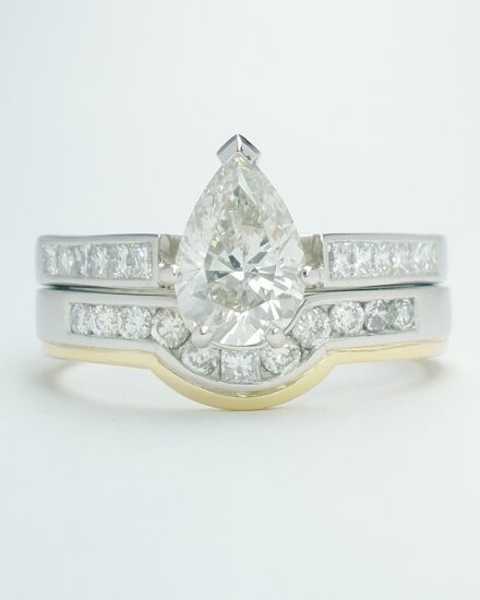 An 11 stone channel set round brilliant cut and princess cut diamond platinum and 18ct yellow gold shaped wedding ring.