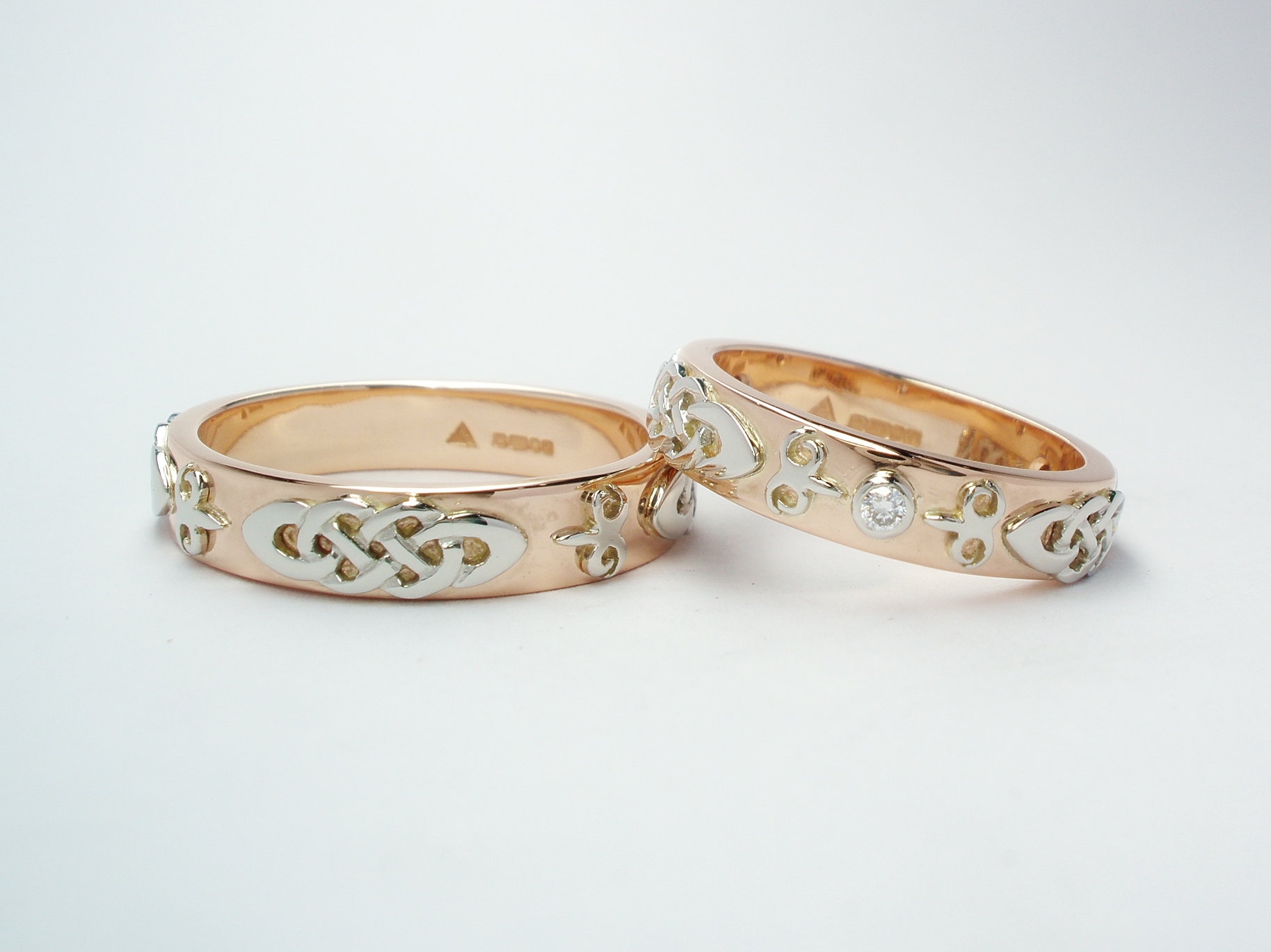 The matching pair or His & Her red gold wedding rings with platinum Celtic & Kazakh style motif overlays.