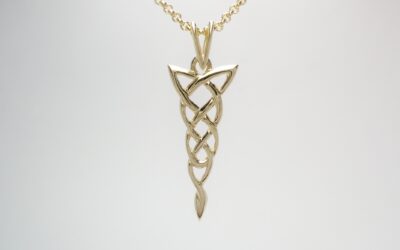 A 9ct. hand carved Celtic pattern pendant.