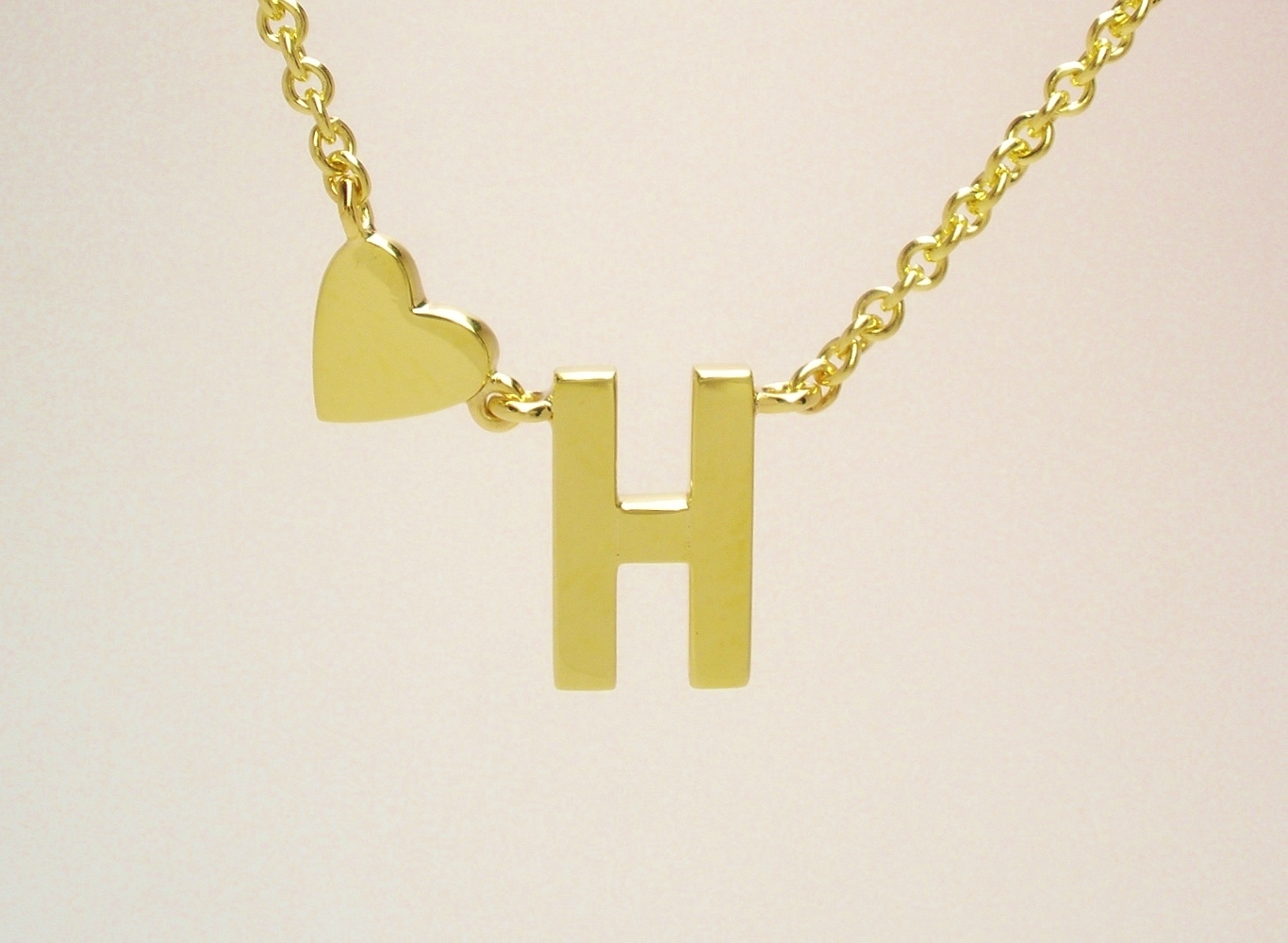 A 9ct. yellow gold initial 'H' and heart pendant created from a deceased family members wedding ring.