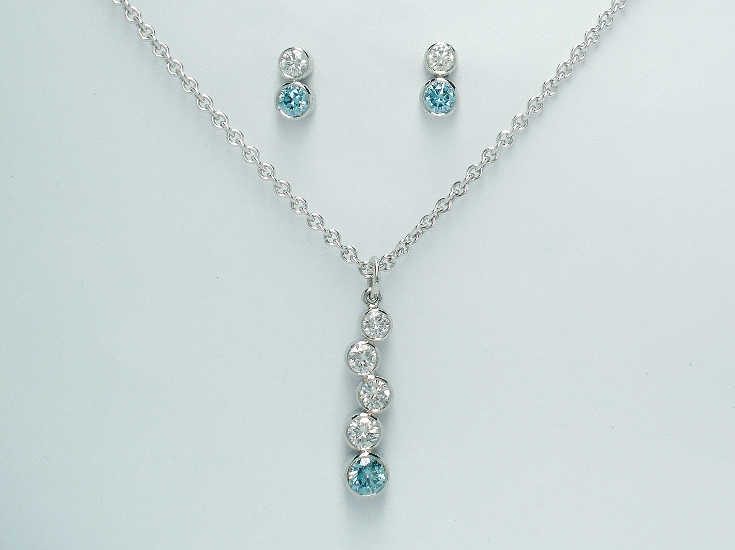 The 5 stone sky blue and white tumble pendant along with the complimenting 2 stone sky blue and white diamond ear studs
