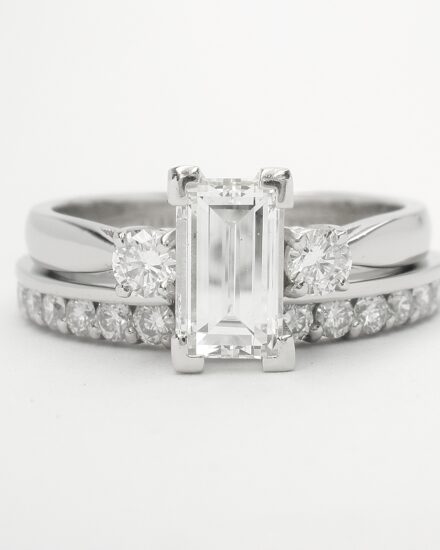 A 16 stone part channel set round brilliant cut diamond ring shaped to firt with a baguette and brilliant cut 3 stone engagement ring.