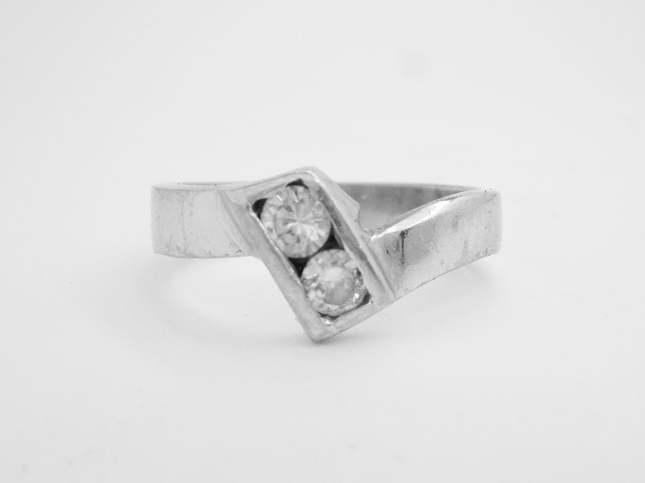 A 2 stone round brilliant cut diamond wedding ring to fit a single stone Princess cut cross-over engagement ring. Single stone princess cut diamond cross-over engagement ring. Very chunky & no finesse.