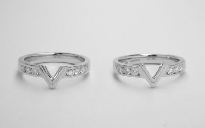 A pair of platinum rings shaped to fit around a single stone marquise diamond ring and channel set with 6  round brilliant cut diamonds.