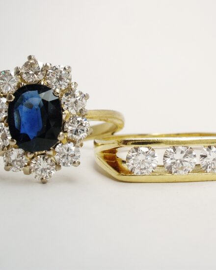 A 3 stone round brilliant cut diamond ring and an 11 stone oval sapphire and diamond cluster. Only the diamonds were to be used.