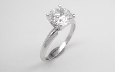 Before, a 1.90ct. single round brilliant cut diamond set in a 4 heavy clawed setting with no support bearer for the diamond and a low parallel shank. After, the 1.90ct. round brilliant cut diamond set in a finer clawed 6 claw setting with support bearer and a tapered knife edged shank with an elegant height.