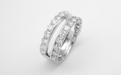 A platinum 28 stone round brilliant cut diamond part channel set double wedding ring with slot to insert single stone diamond engagement ring.