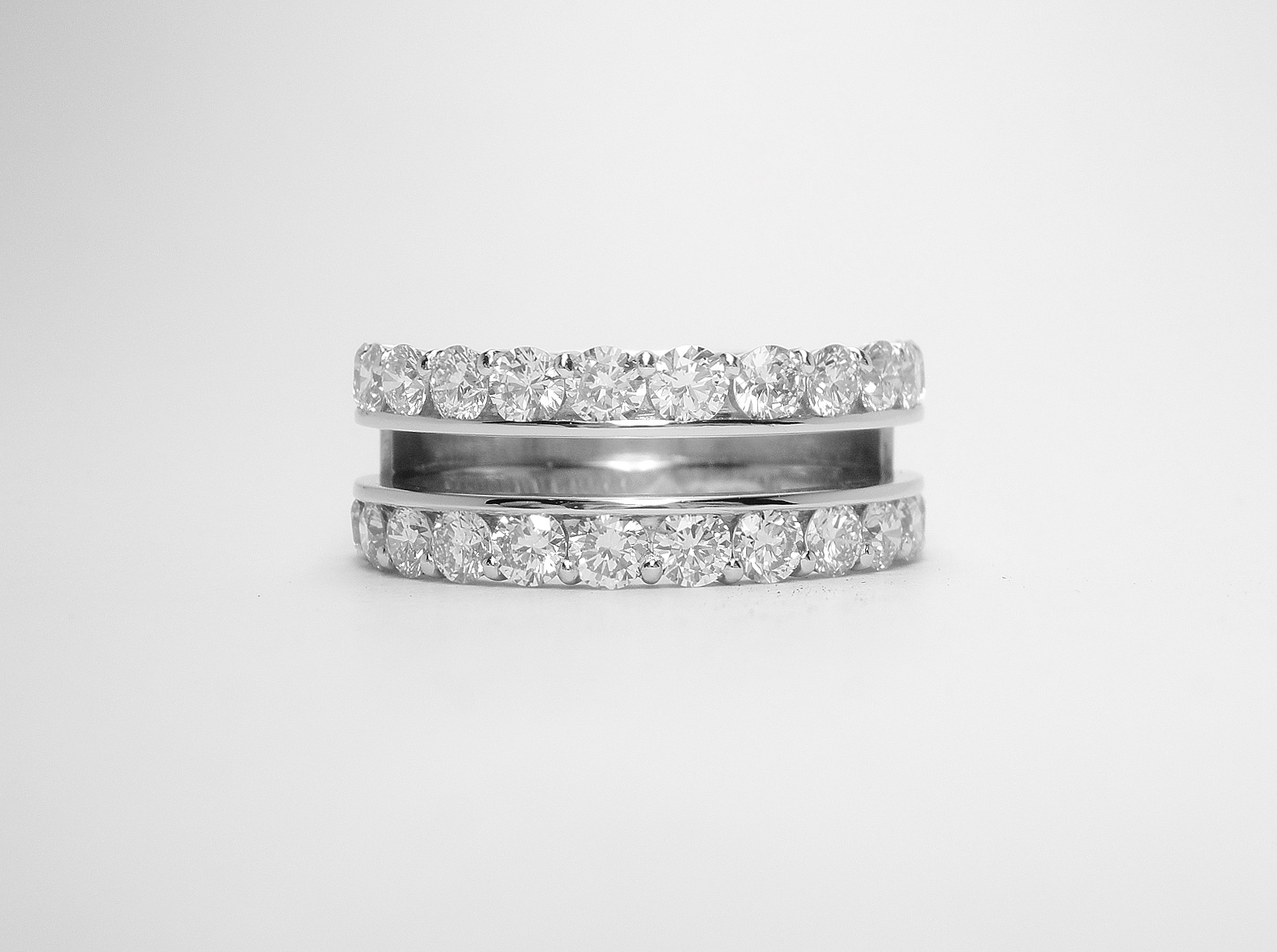 The double part channel set wedding ring showing the slot to accept the wedding ring and the plate at the back to which both are attached.