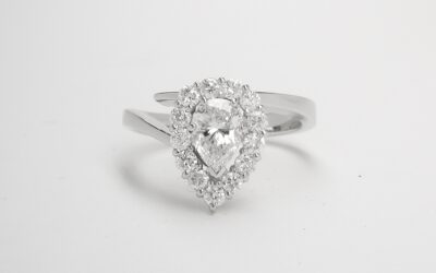 A 14 stone pear shaped 'Halo' cluster straight wishbone cross-over styled ring mounted in platinum.