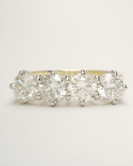 4 stone round brilliant cut diamond ring remounted in a modern platinum peg style setting