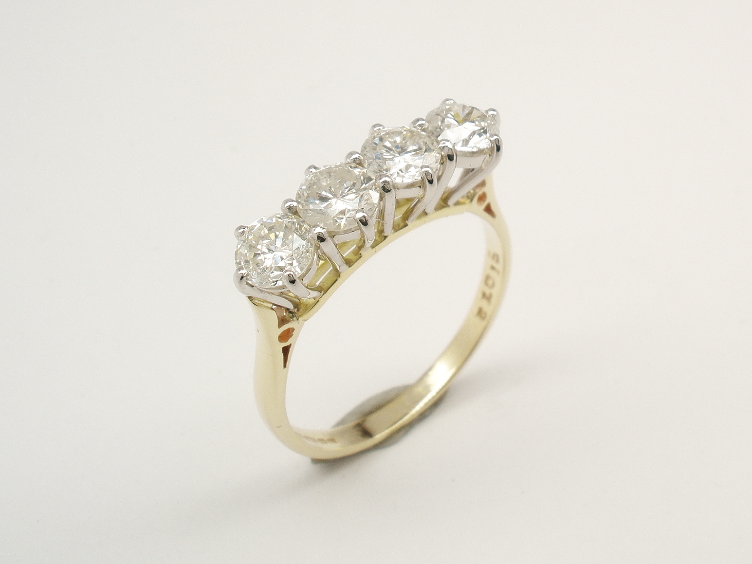 4 stone round brilliant cut diamond ring remounted in a modern platinum peg style setting