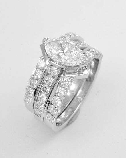 A pair of 10 stone round brilliant cut part channel set wedding rings shaped with a central 'V' shaped panel to fit around a single stone marquise diamond ring. The pair of 10 stone part channel set rings fitting with the single stone marquise diamond ring.