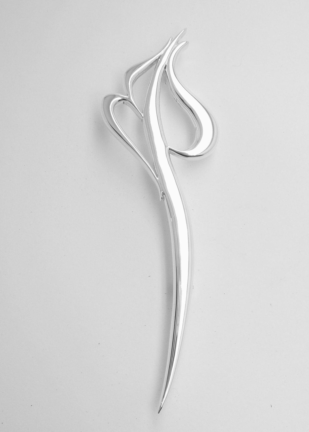 A stylised initial 'S, S, M' sterling silver kilt pin.