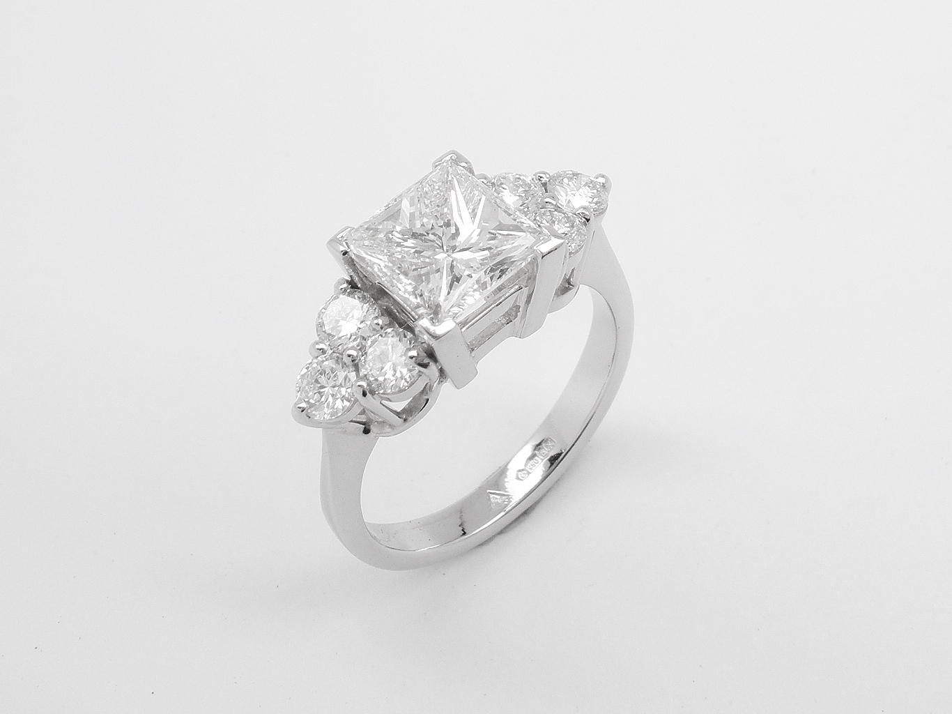 A 7 stone princess cut and round brilliant cut diamond ring mounted in platinum.