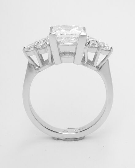 A 7 stone princess cut and round brilliant cut diamond ring mounted in platinum.