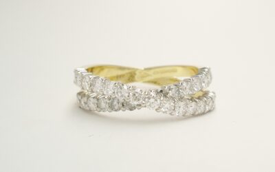 A 29 stone round brilliant cut diamond 'X' style cross-over ring mounted in 18ct. yellow gold and platinum.