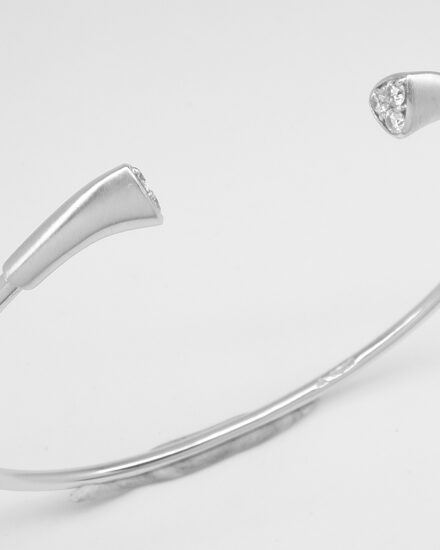platinum torque bangle with 6 round brilliant cut diamonds set into the ends