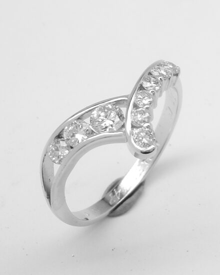A 9 stone round brilliant cut diamond both channel set and part channel set wishbone style ring mounted in platinum.