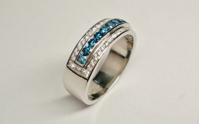 3a. A 53 stone channel set ocean blue and white round brilliant cut diamond ring mounted in platinum. The ocean blue diamonds are raised a little higher across the top.