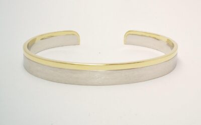 A gents platinum and 18ct. yellow gold torque bangle. The platinum with a brushed finish & the gold a polished finish.