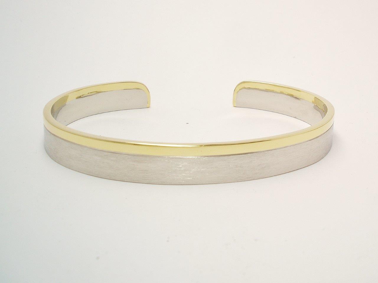 A gents platinum and 18ct. yellow gold torque bangle. The platinum with a brushed finish & the gold a polished finish.