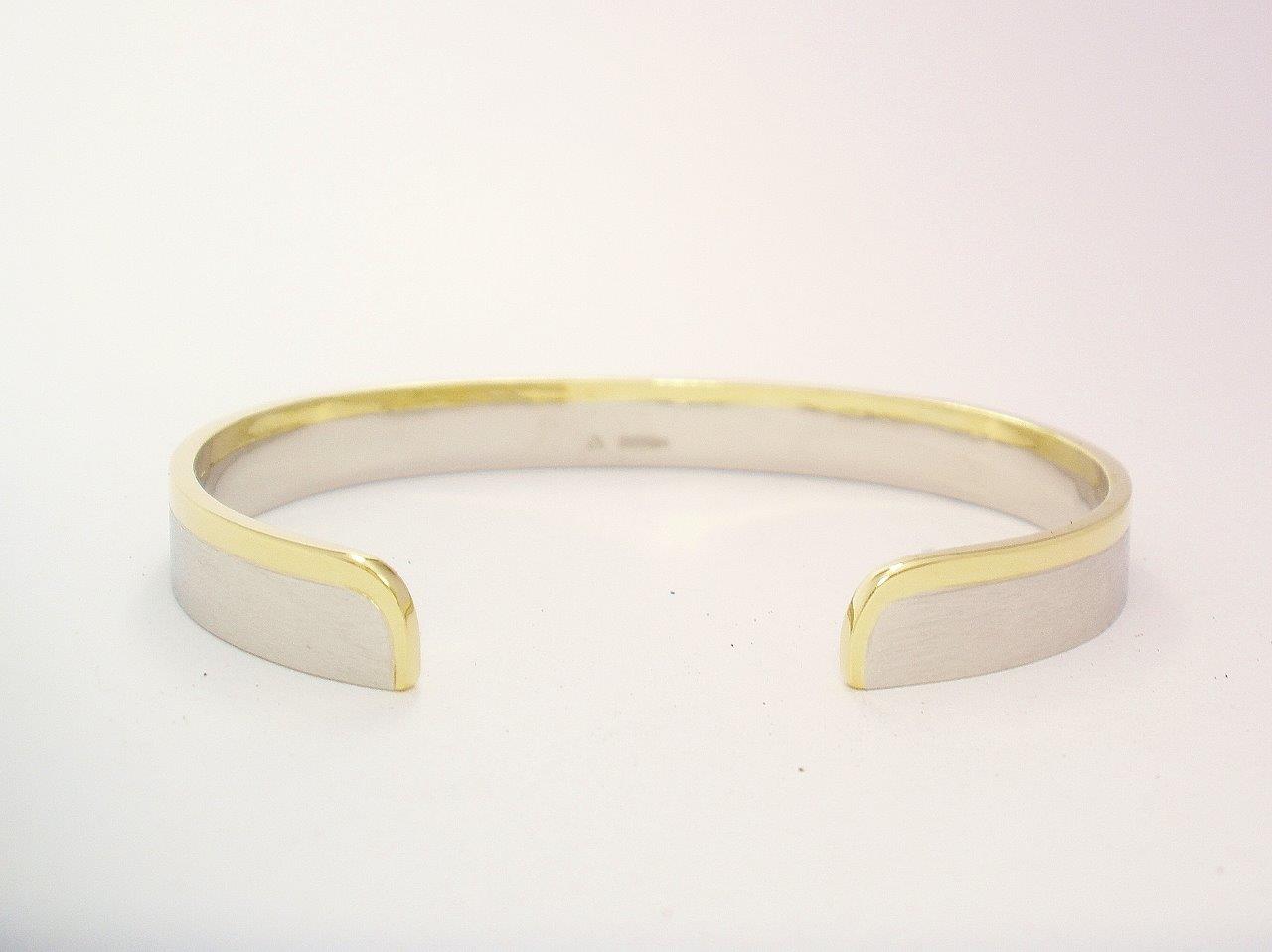 A gents platinum and 18ct. yellow gold torque bangle. The platinum with a brushed finish & the gold a polished finish.