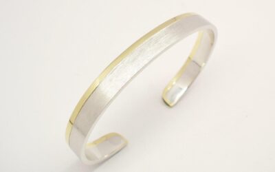 A gents platinum and 18ct. yellow gold torque bangle. The platinum with a brushed finish & the gold a polished finish.