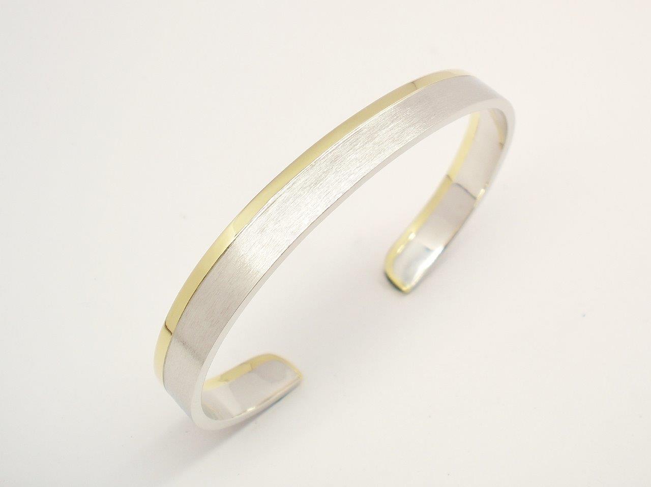 A gents platinum and 18ct. yellow gold torque bangle. The platinum with a brushed finish & the gold a polished finish.