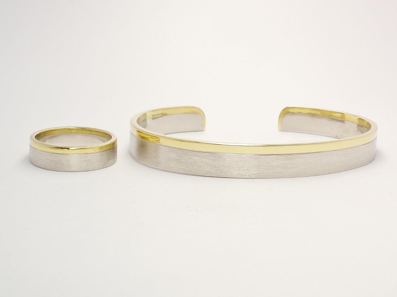 A gents platinum and 18ct. yellow gold wedding ring and torque bangle. The platinum with a brushed finish & the gold a polished finish.