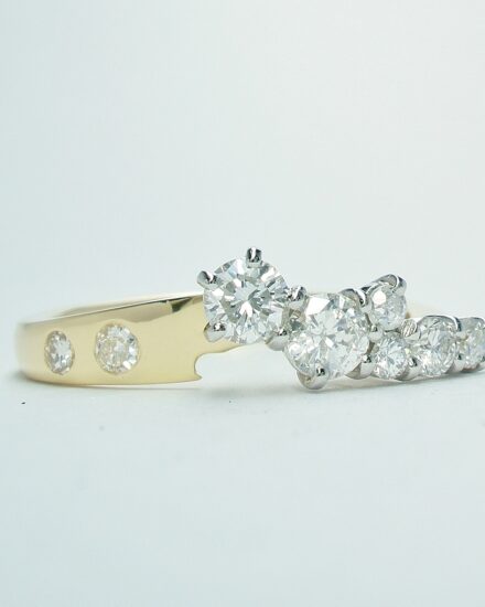 An 8 stone diamond ring mounted in 18ct. yellow gold and platinum shaped to fit with a single stone diamond ring.