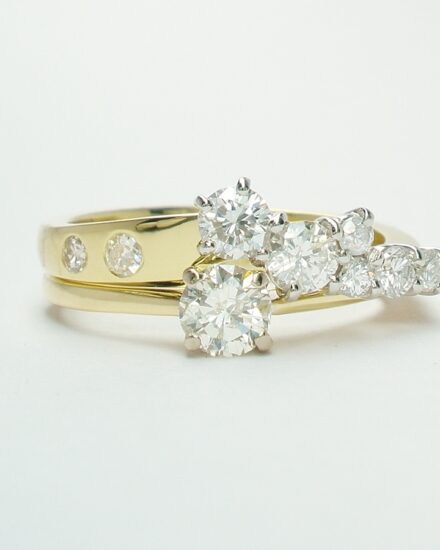 An 8 stone diamond ring mounted in 18ct. yellow gold and platinum shaped to fit with a single stone diamond ring.