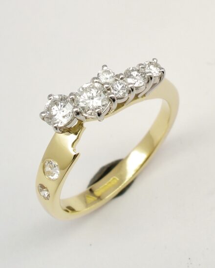 An 8 stone diamond ring mounted in 18ct. yellow gold and platinum shaped to fit with a single stone diamond ring.